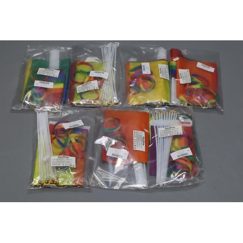 699 - Seven Packs of Gay Pride Decorations. Each Pack Includes Ten Wrist Bands, One Flag, And Ten Flag Sti... 