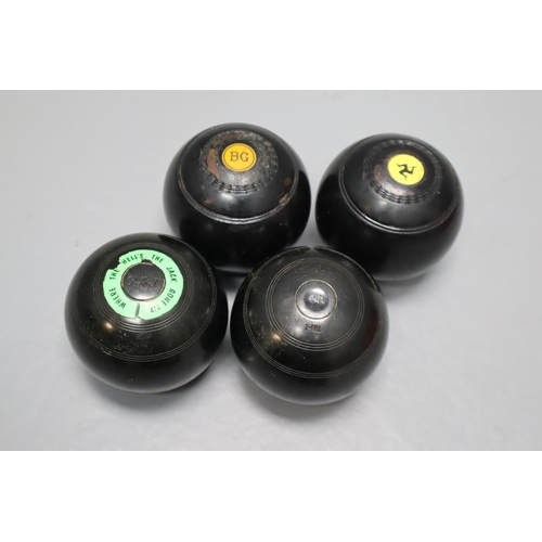 712 - A pair of Thomas Taylor Bias 2 full lawn bowls & a a pair of Crystalate 2 full P A J lawn bowls.