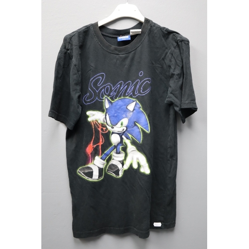 715 - Three Small Pre-Owned Promotional T-Shirts to include Batman V Superman, Sonic and Gold and Silver P... 