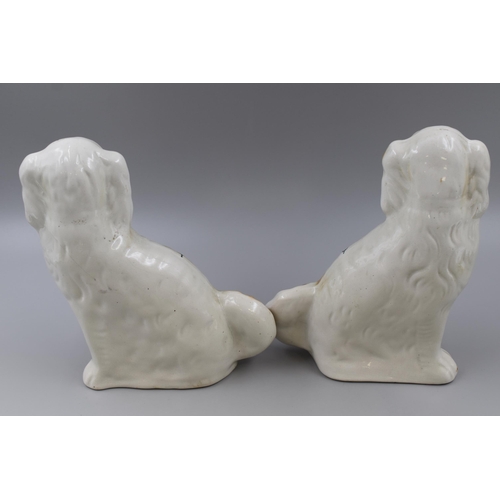 254 - A pair of antique Staffordshire spaniels measuring 10