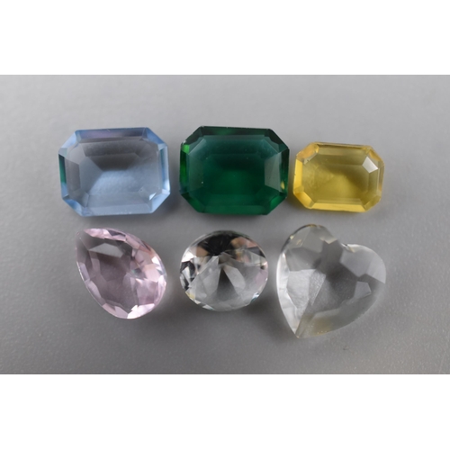Six Geologically Laboratory Grown and Tested Moissanite Stones to include a 2ct Heart Shaped Gem, Three 2ct Emerald Cut Gems, Pink Pear Cut Gem and a Diamond Cut Light Blur Gemstone