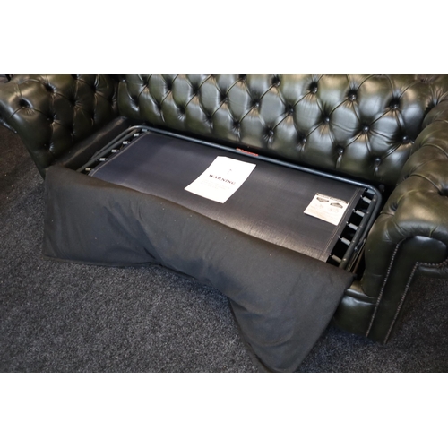 660 - Button Back Green Leather Chesterfield Three Seater Settee in good usable condition approx has integ... 