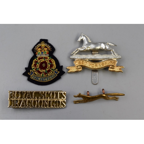 279 - Four Military Badges including West Yorkshire, Queens Lancashire Berry Badge, Royal Scots Dragoon Gu... 