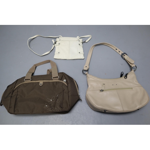 763 - Three ladies bags to include Stone mountain beige shoulder bag, American tourister brown canvas hold... 