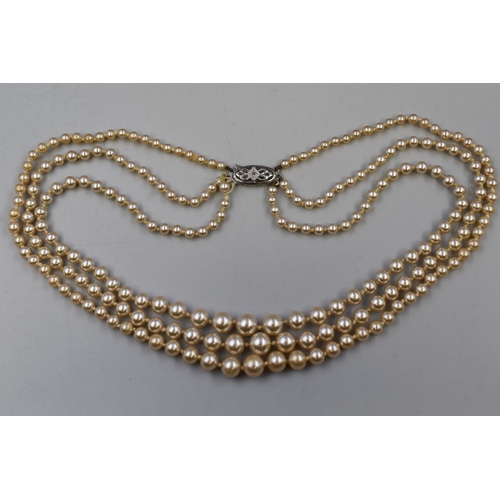 98 - A Lotus 9ct White Gold Clasped Three Strand Pearl Necklace, In Presentation Box