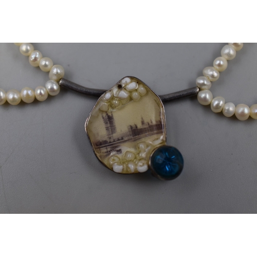 213 - A 925. Silver Clasped Two Strand Pearl Necklace With Houses of Parliament and Blue Stoned Centre, An... 