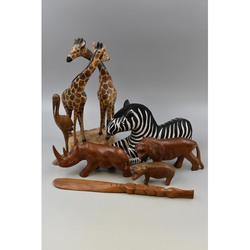 750 - Seven Wooden Hand Carved Animal Figures including Giraffe, Zebra and a Crocodile Shoe Horn