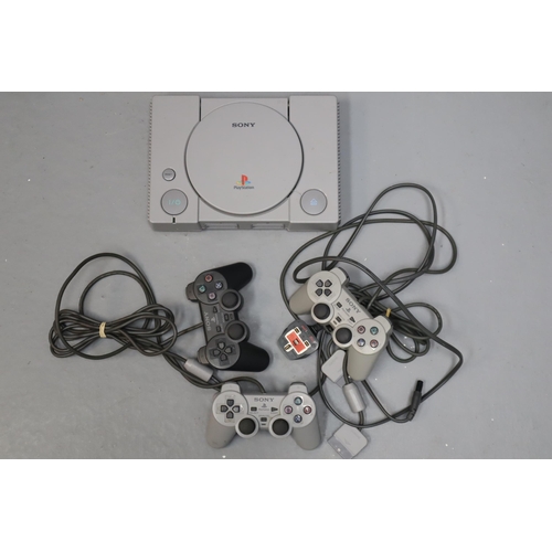 572 - Playstation 1 with 3 Dual Shock Controllers and Original Box (Powers On When Tested)