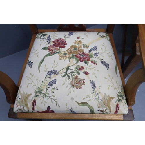 574 - Two Carver arm chairs in light wood with floral upholstery (41