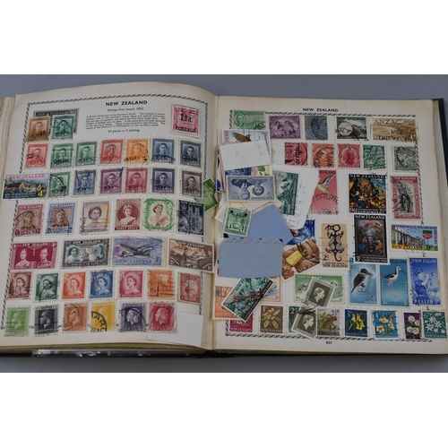 153 - The Triumph Stamp Album containing a Large Selection of GB and Worldwide Stamps Dating From Queen Vi... 