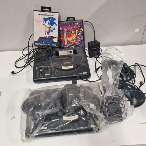 562 - Two Sega Megadrive Games Consoles. Power on but untested beyond that. Comes with 2 Games.