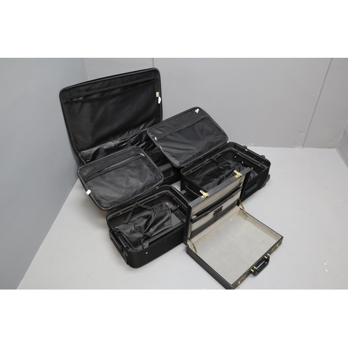 845 - Three black matching suit cases largest 29