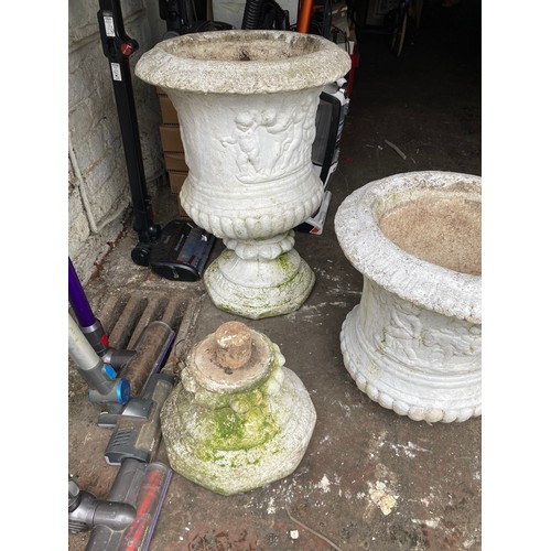 591 - Two heavy white garden stone urns with separate pedestals measuring 19