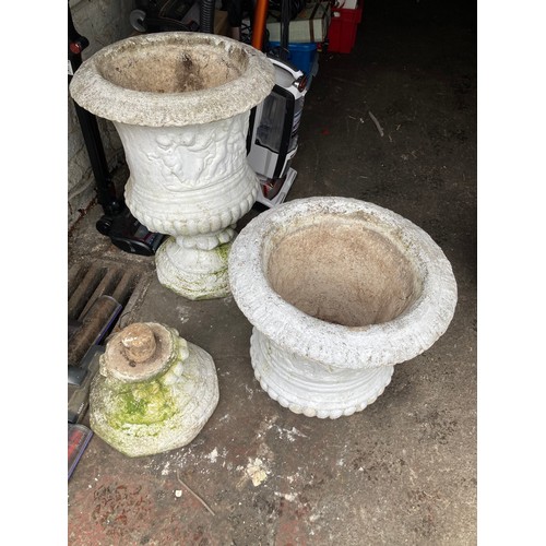 591 - Two heavy white garden stone urns with separate pedestals measuring 19