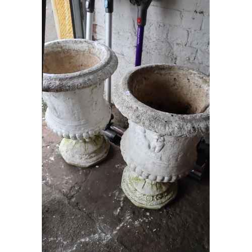 591 - Two heavy white garden stone urns with separate pedestals measuring 19