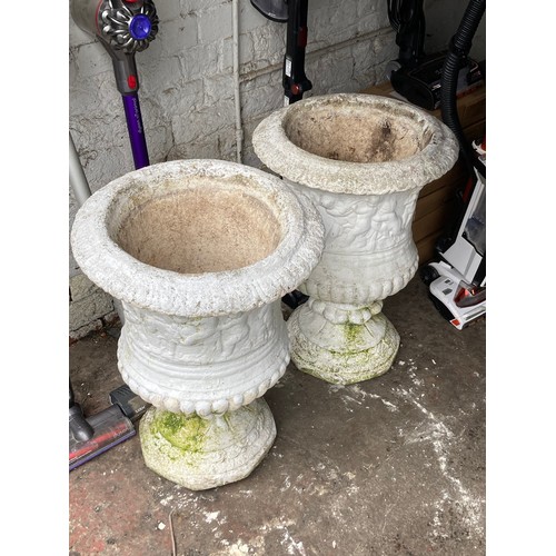 591 - Two heavy white garden stone urns with separate pedestals measuring 19