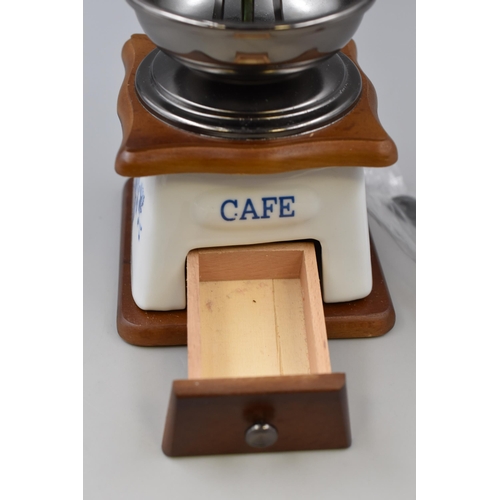 268 - New and unused coffee grinder with blue flower pattern measures 5.5