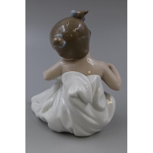 297 - Fine Quality Porcelain Nao Statue of a Child Wrapped in a Blanket