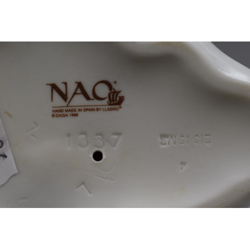 297 - Fine Quality Porcelain Nao Statue of a Child Wrapped in a Blanket