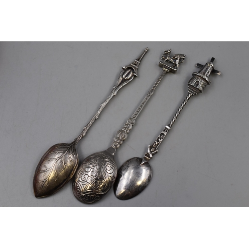 142 - Three Vintage spoons including A Dutch windmill themed spoon, A Paris Eiffel Tower themed spoon and ... 