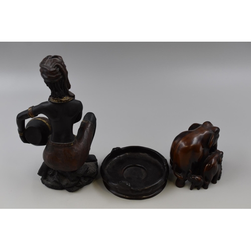 335 - An African women figurine with barrel and An Elephant family Ornament with tray