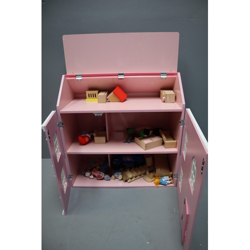 654 - Child's Pink Wooden Dolls House Complete with Furniture and Little People 23