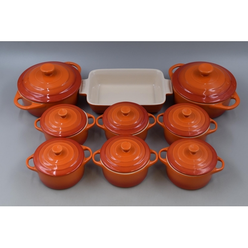 410 - A selection of orange casserole dishes with lids, six 4