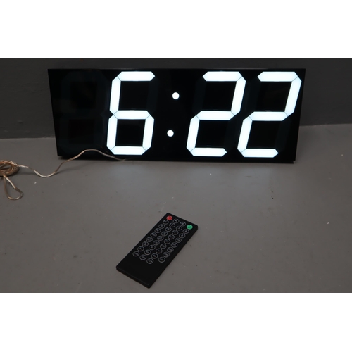 675 - Brand New Boxed Large LED Digital Wall Clock complete with Remote, Powers on when tested