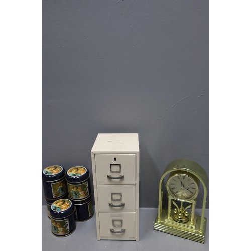 894 - Metal Filing Cabinet themed Money Box with Key, Quartz Mantle Clock and a Set of 5 Decorative Tins