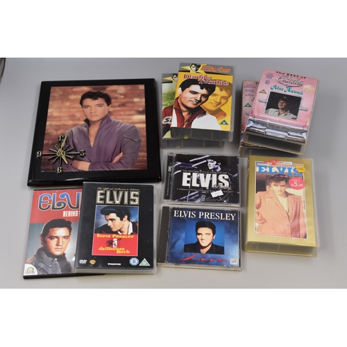 509 - A Mixed lot of Elvis Presley items to include: An Elvis clock, CDs and DVDs