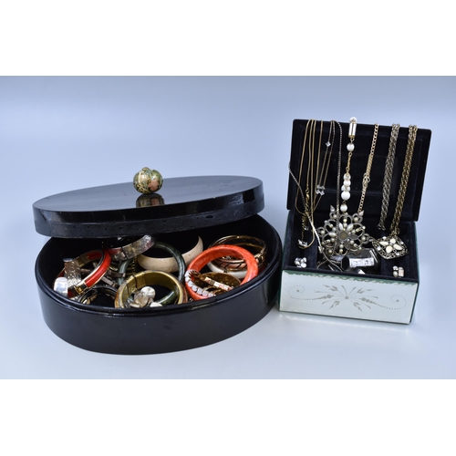 452 - Two jewellery boxes containing costume jewellery, to include bangles, cuff links, necklace's and mor... 