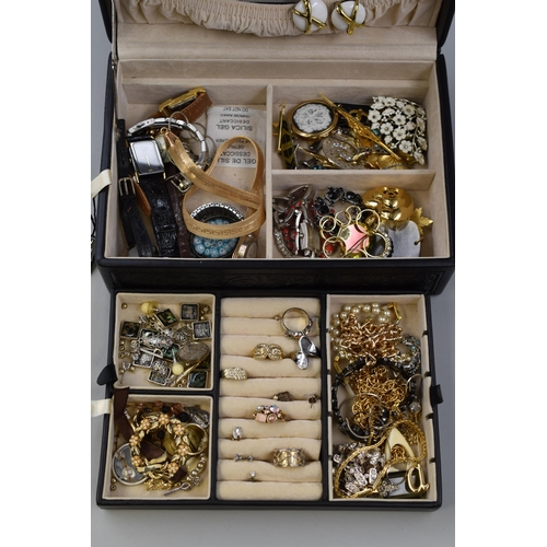 461 - A vintage black patterned jewellery box includes an unsorted mix of jewellery with some 925 Silver