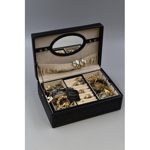 461 - A vintage black patterned jewellery box includes an unsorted mix of jewellery with some 925 Silver