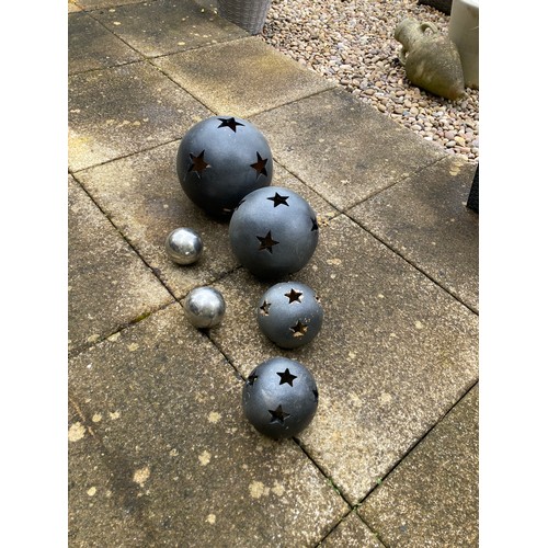 852 - Selection of garden ornament balls to include 4 black terracotta with star shaped holes (large hole ... 