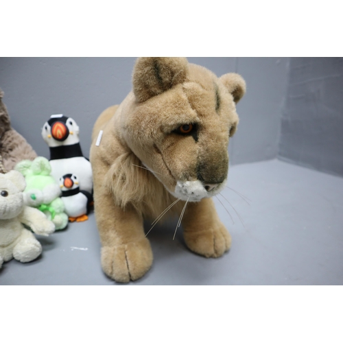 806 - A selection of teddy bears to include: A puffin doorstop, dog, lion and more