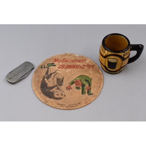 221 - Three Pieces of Guinness Advertising Pieces. Includes Miniature Tankard, Beer Mat, And Pocket Knife