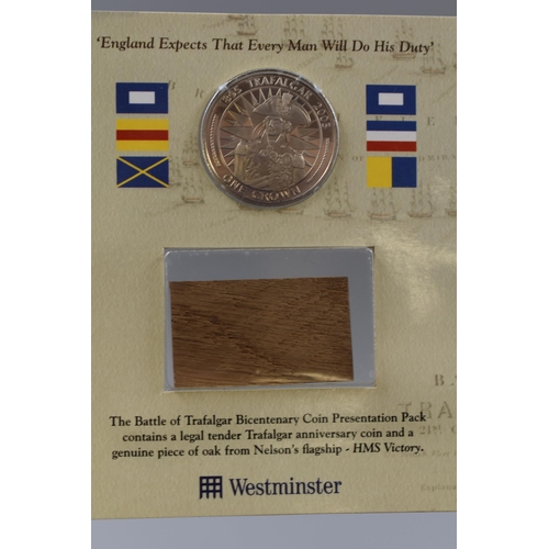 154 - Battle of Trafalgar Crown set with a piece of oak from HMS Victory, a First Decimal Coin Set and thr... 