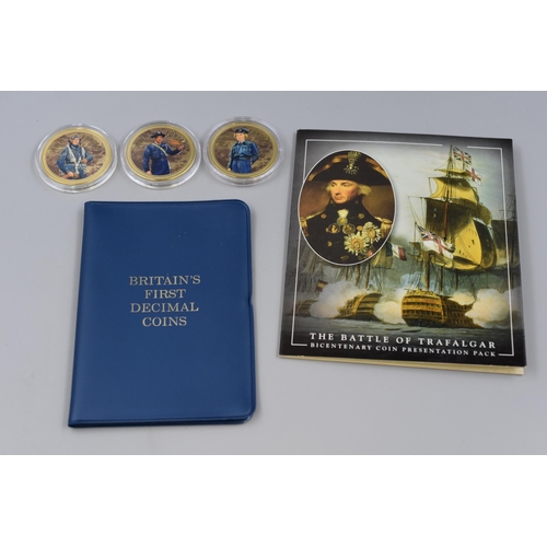 154 - Battle of Trafalgar Crown set with a piece of oak from HMS Victory, a First Decimal Coin Set and thr... 