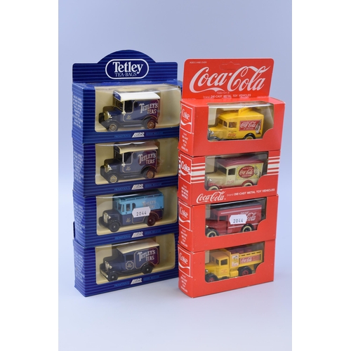 619 - Four Coca-cola diecast model trucks & 4 Tetly's Tea diecast trucks