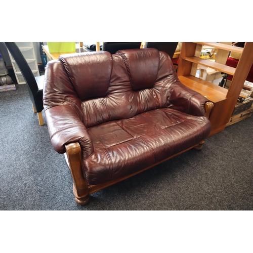 674 - Burgundy two seater leather sofa with pine wooden finish (55