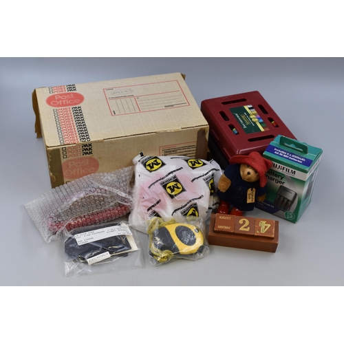 842 - A mixed lot of items to include: bookmarks, badges, luggage tags, paddington bear figurine and more