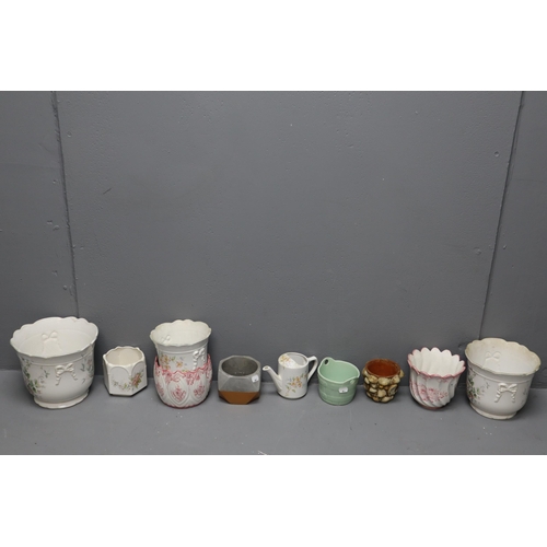 857 - A Selection of Nine Planters And a Ceramic Watering Can To Include Set of Three Graduating Floral Pl... 