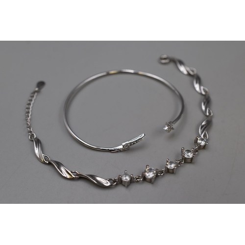 224 - Silver 925 Clear Stoned Bracelet and a Moon and Star Bangle