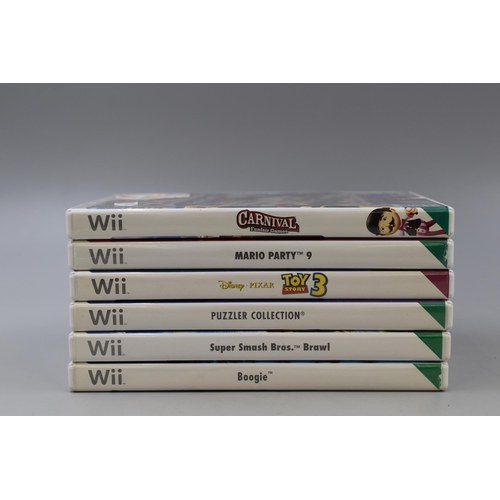 466 - Six Wii games & a Wii Rabbid Grip to include: Mario Party 9, Toy Story 3, Puzzler, Super Smash B... 