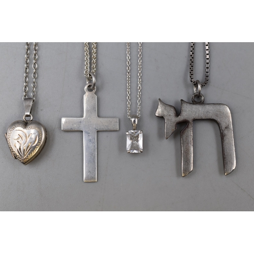 47 - Four silver 925 necklaces to include a heart locket, a cross, a little drop and a Chai pendant all o... 