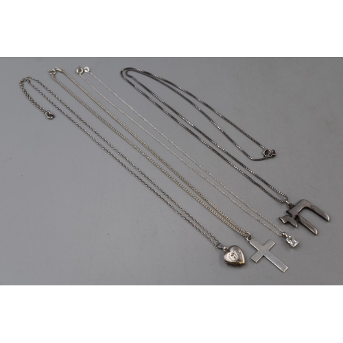 47 - Four silver 925 necklaces to include a heart locket, a cross, a little drop and a Chai pendant all o... 