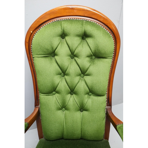 627 - Victorian dark wooden spoon back arm chair with dark green buttoned upholstery (44