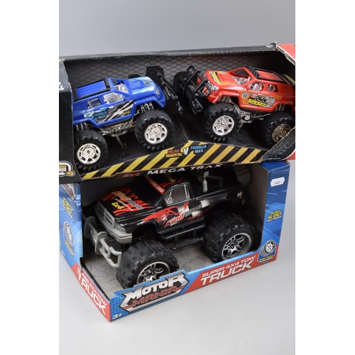 468 - Collection of Four Boxed Friction Power Vehicles To Include Monster Trucks and Two Racing Cars, Comp... 