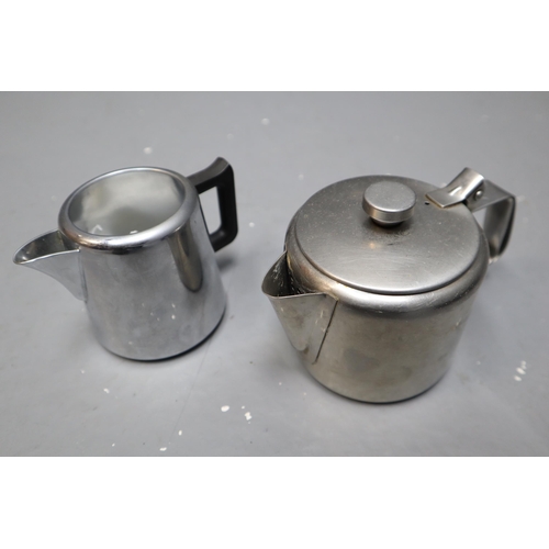 824 - Box full of stainless steel items to include tea pots, toast rack and more