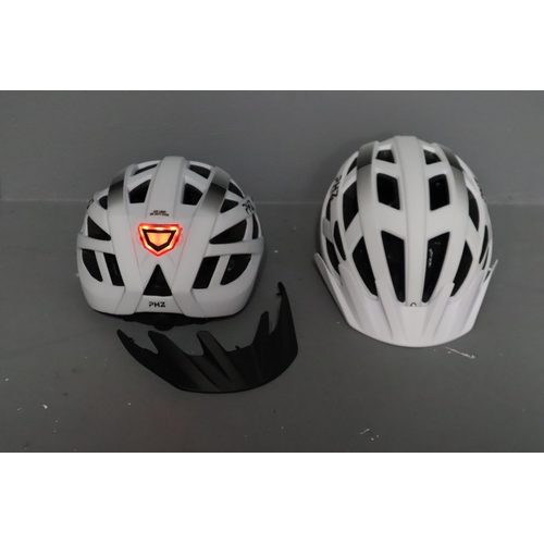 675 - Two new matching large and medium bike helmets (rechargeable)